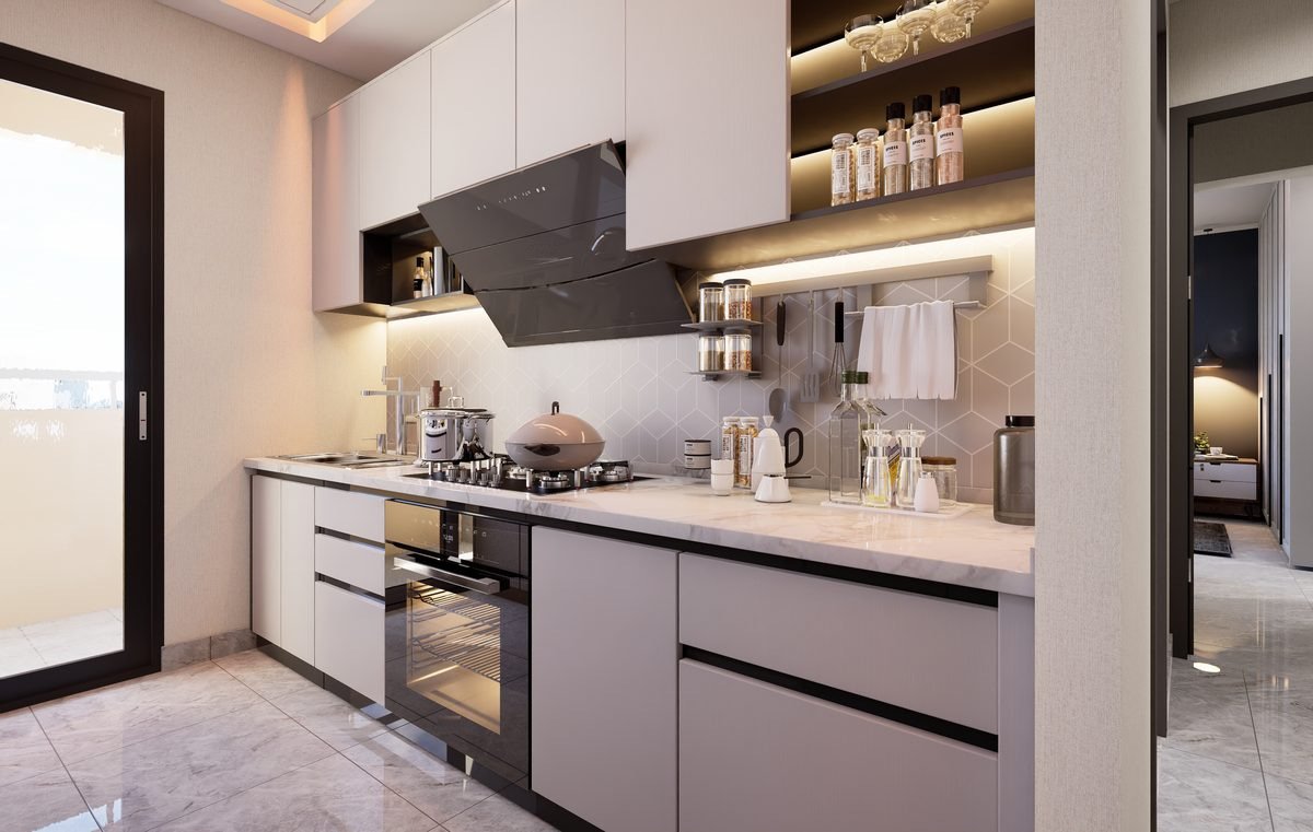 Kitchen of a 2 BHK apartment with overhead cabinets and a window to the balcony